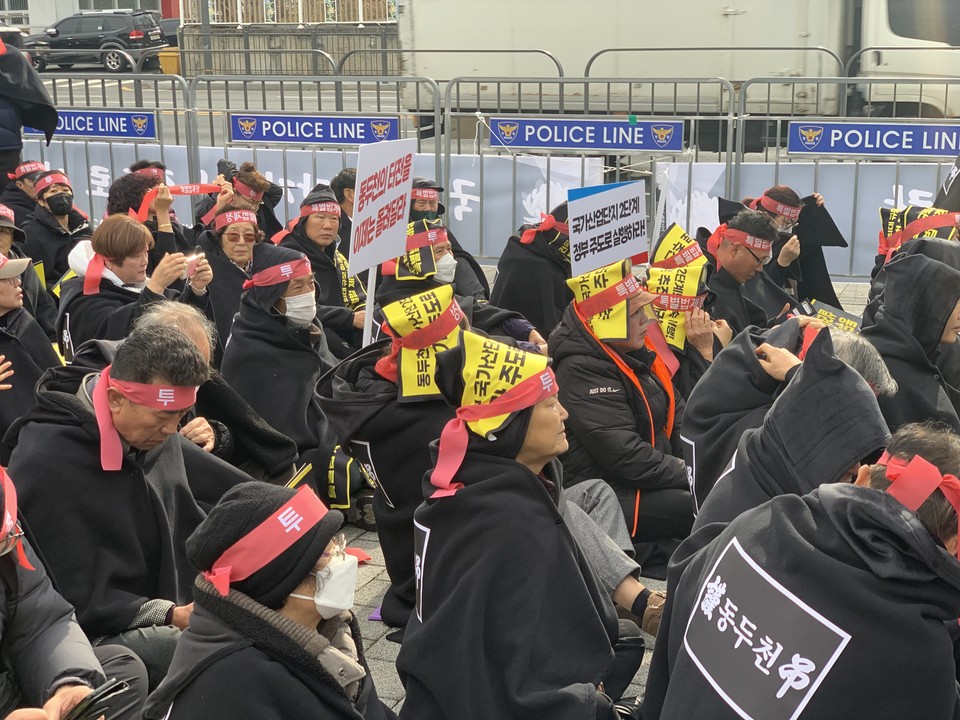 집회 장소에서 슬로건이 써 있는 머리띠를 두르고 있는 동두천시민들. (사진=오기춘 기자)